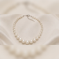 White pearl necklace on satin background