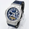 Blue skeleton dial luxury wristwatch with a silver stainless-steel case, blue strap, and visible gold mechanical movement.