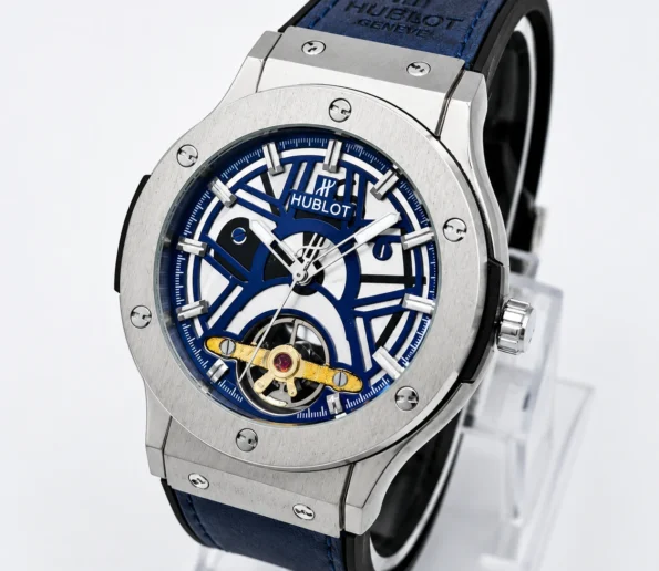 Blue skeleton dial luxury wristwatch with a silver stainless-steel case, blue strap, and visible gold mechanical movement.