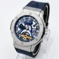 Blue skeleton dial luxury wristwatch with a silver stainless-steel case, blue strap, and visible gold mechanical movement.