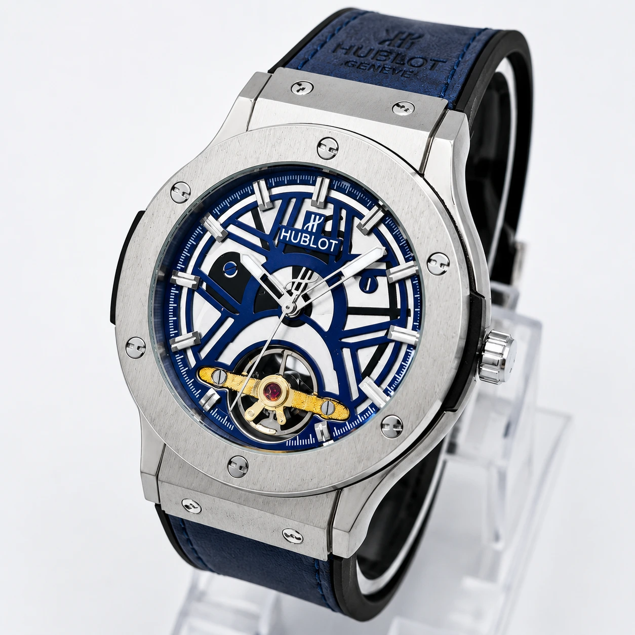 Blue skeleton dial luxury wristwatch with a silver stainless-steel case, blue strap, and visible gold mechanical movement.