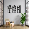 Modern interior with black floral wall art, wooden chair, green indoor plant, and large windows.