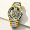 Gold and silver skeleton watch with intricate mechanical gears and metal bracelet