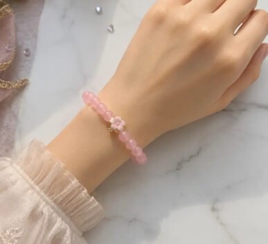 Pink beaded bracelet with flower charm