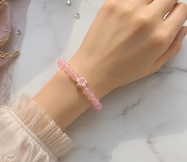Pink beaded bracelet with flower charm