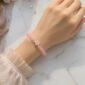 Pink beaded bracelet with flower charm