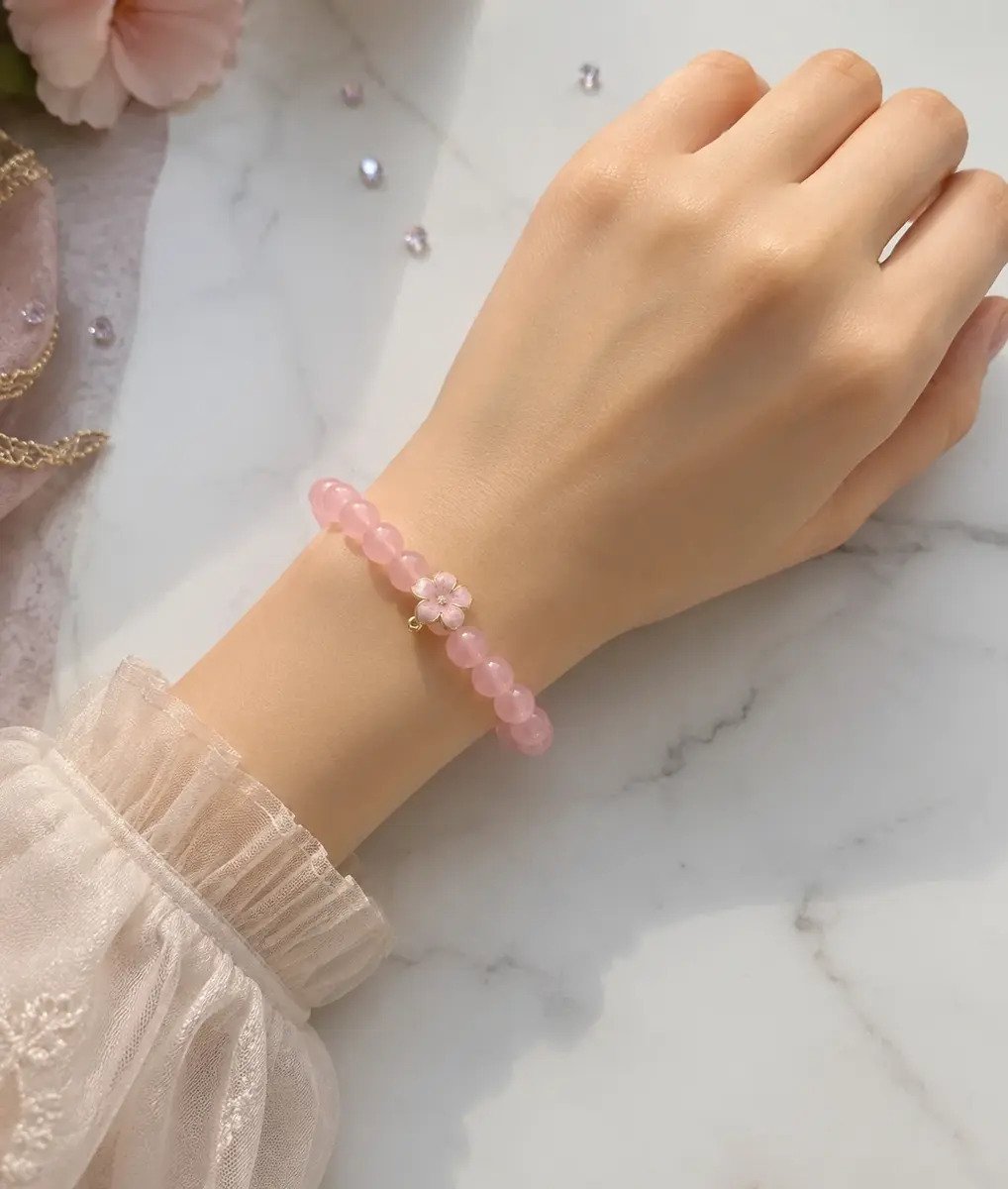 Pink beaded bracelet with flower charm