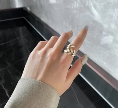 Elegant gold floral ring worn on a hand