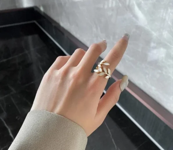 Elegant gold floral ring worn on a hand
