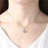 Elegant silver flower pendant necklace worn on a model