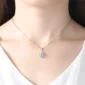 Elegant silver flower pendant necklace worn on a model