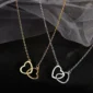 Gold and silver heart-shaped necklaces displayed on black fabric