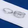 Elegant silver diamond rings with sparkling stones on a white surface