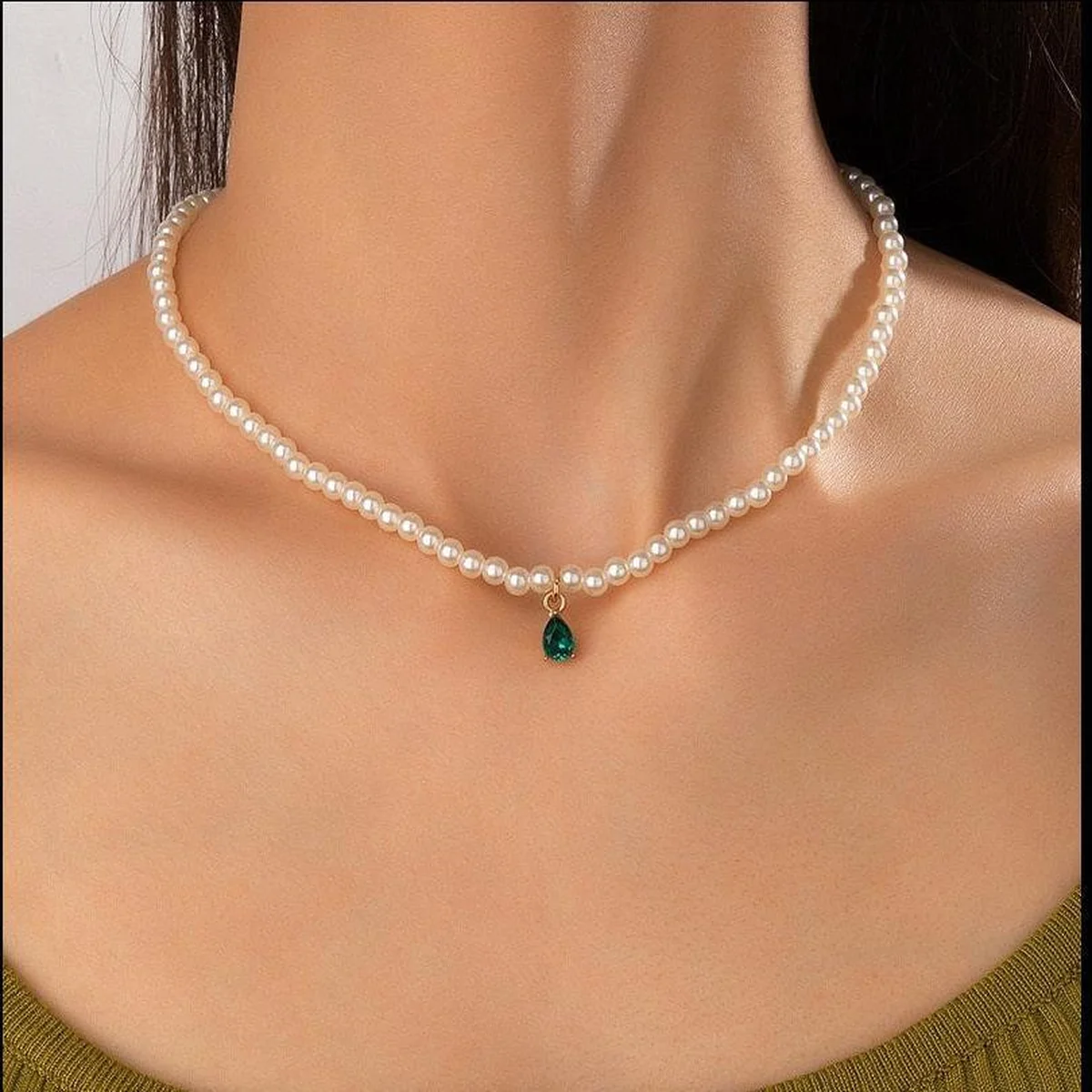 Pearl necklace with green teardrop pendant