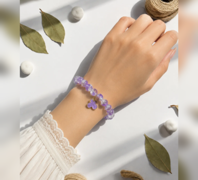 Purple beaded bracelet with flower charm
