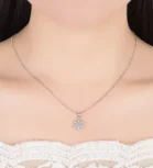 Elegant silver snowflake pendant necklace on a model