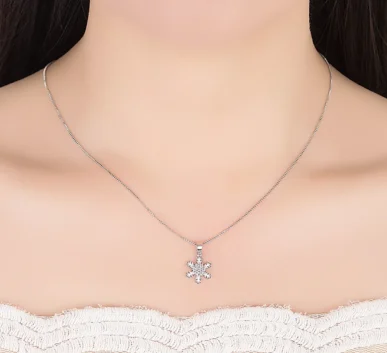Elegant silver snowflake pendant necklace on a model
