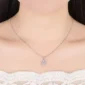 Elegant silver snowflake pendant necklace on a model