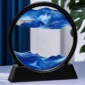3D moving sand art in blue ocean design with flowing sand waves inside a round glass frame.