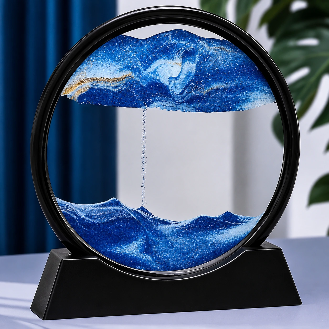 3D moving sand art in blue ocean design with flowing sand waves inside a round glass frame.