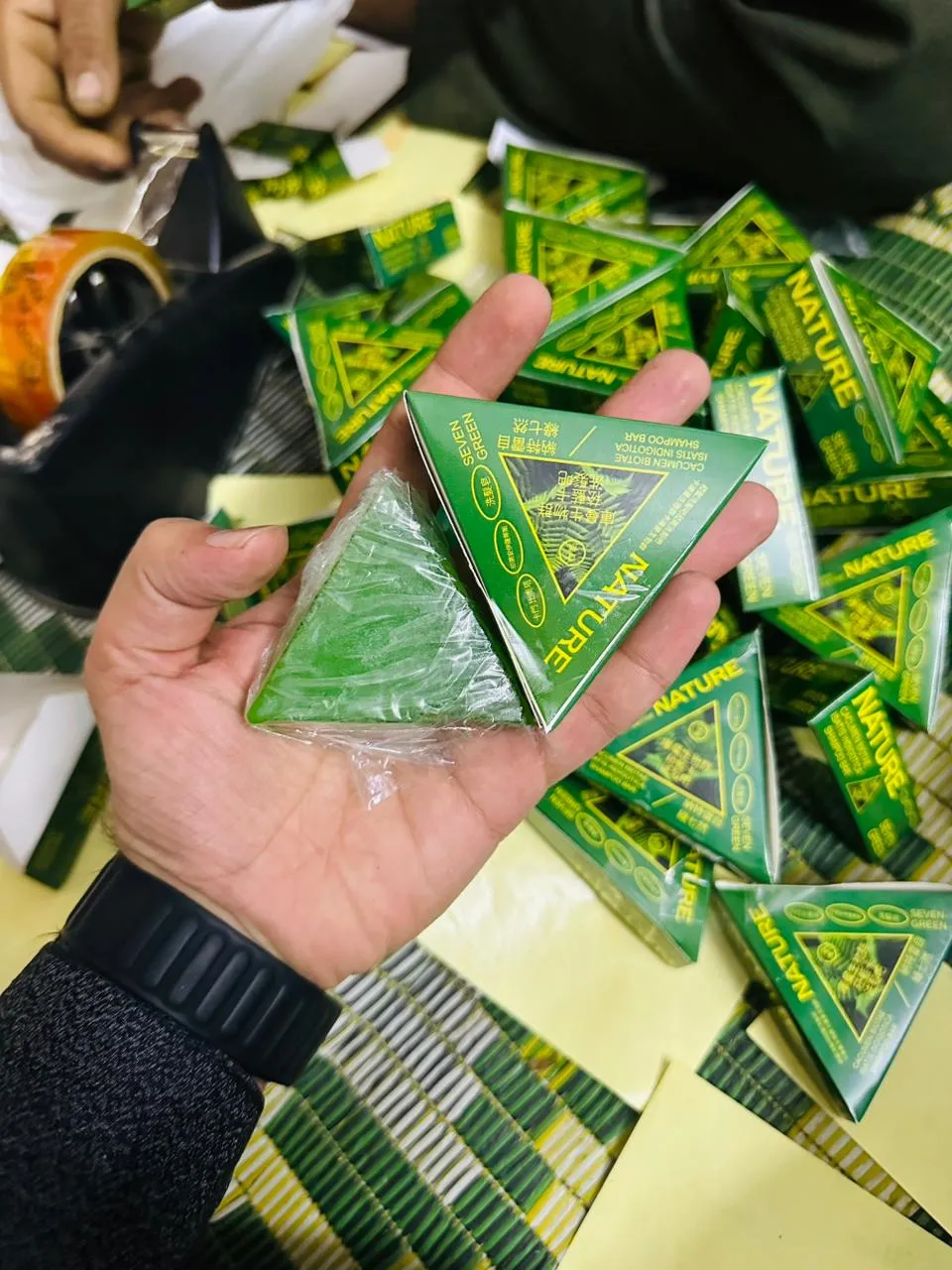 Seven Green Nature Herbal Triangular Green Packets in Hand