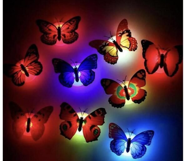 Colorful decorative butterflies illuminated by red, blue, green, yellow, and purple lights on a dark background