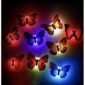 Colorful decorative butterflies illuminated by red, blue, green, yellow, and purple lights on a dark background