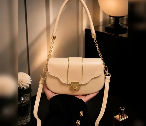 Beige women’s shoulder bag with gold chain and long strap