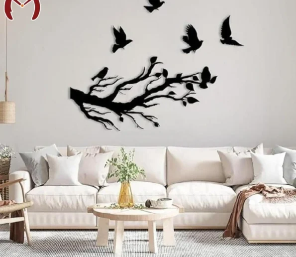 Black tree branch and flying birds wall decor in a modern living room