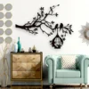 Black tree branch wall decor with birds and hanging birdcage in a modern living room