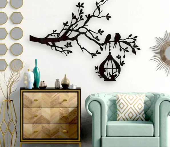 Black tree branch wall decor with birds and hanging birdcage in a modern living room