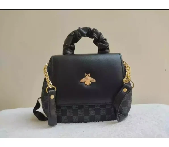 Black handbag with gold chain strap and bee-shaped decorative emblem