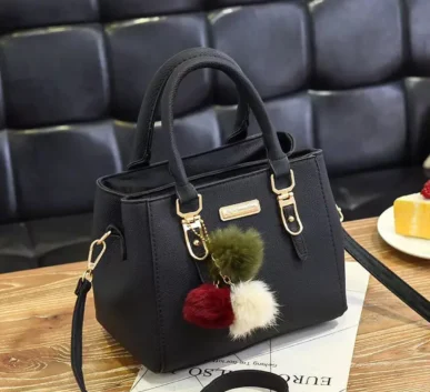 Black structured women’s handbag with gold-tone hardware, top handles
