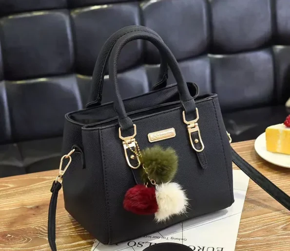 Black structured women’s handbag with gold-tone hardware, top handles