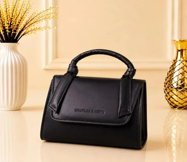 Black structured women’s handbag with top handle