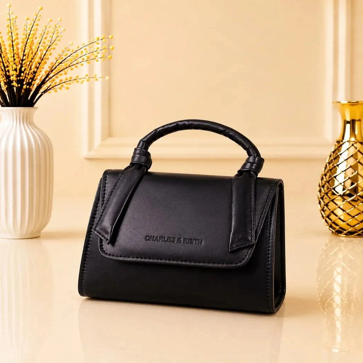 Black structured women’s handbag with top handle