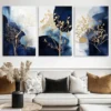 Blue and gold three-panel tree wall art above a modern living room sofa