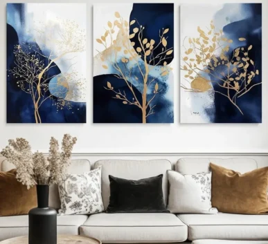 Blue and gold three-panel tree wall art above a modern living room sofa