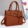 Brown women’s handbag with bow detail and shoulder strap