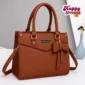 Brown women’s handbag with bow detail and shoulder strap