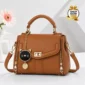 Brown women’s handbag with gold details and cat charm