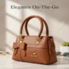 Brown leather handbag with bow design and gold accents
