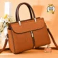 Elegant brown women’s handbag with top handles, front zipper, and shoulder strap.