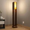 Modern wooden floor lamp with warm ambient light and a tall decorative design for home interiors.