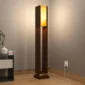 Modern wooden floor lamp with warm ambient light and a tall decorative design for home interiors.
