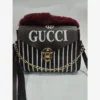 Black and white striped Gucci handbag with fur trim