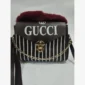 Black and white striped Gucci handbag with fur trim