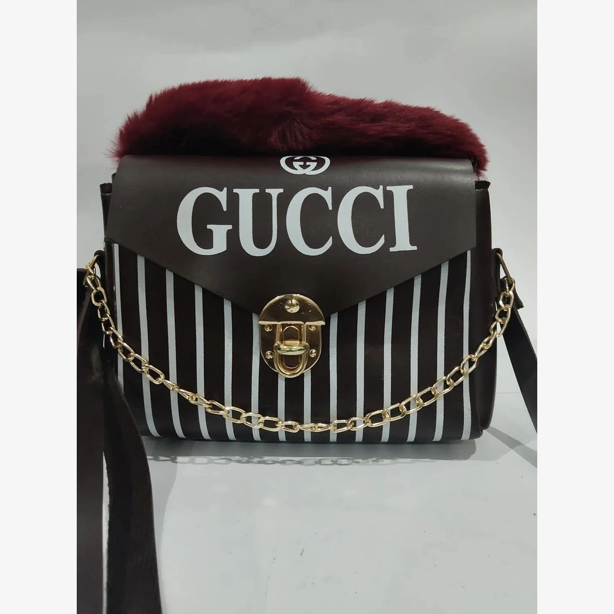 Black and white striped Gucci handbag with fur trim