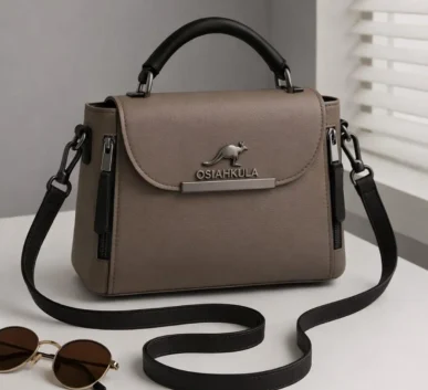 Taupe women’s handbag with black top handle and adjustable shoulder strap