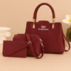 Maroon 3-piece handbag set featuring a handbag, crossbody bag, and matching wallet with gold-tone hardware.